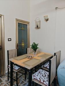 a dining room table with two chairs and a table at Tataicha Appart 3 in NʼDjamena