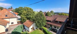 an aerial view of a group of houses with roofs at Pension Hauber - Kirchturmblick in Herrischried