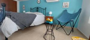 a bedroom with a bed and a blue wall at Villa with Private Pool & Hot tub in Fortuna