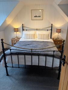 a bedroom with a large bed with two night stands at Waterside House B&B in Ullapool