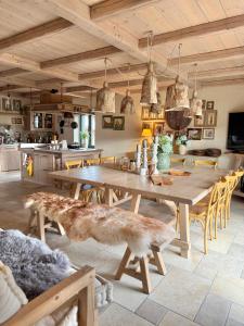 a dining room with a wooden table and chairs at Private Villa for 12 Peaceful Karst Escape in Dutovlje
