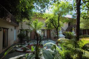 a courtyard of a house with a swimming pool at RJ Hotel Pokhara in Pokhara