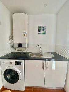 a kitchen with a sink and a washing machine at Atlantic Breeze House I Double Rooms at EL CAMPANARIO I 5 minutes from Popcorn Beach in Corralejo +35 photos