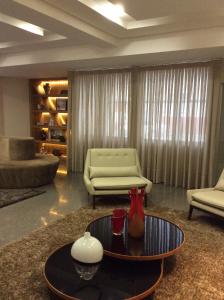 a living room with a couch and a coffee table at Mara Turismo Hotel in Catalão