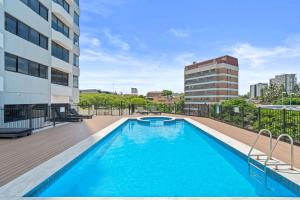a swimming pool on the roof of a building at Riverview Sanctuary - Walk to CBD & South Bank in Brisbane