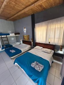 a bedroom with two beds and a window at Punta Pacífico Bungalows Máncora in Máncora +111 photos