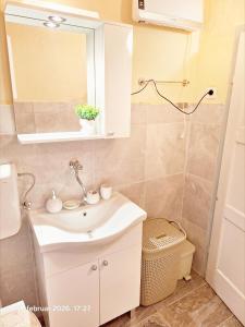 a bathroom with a sink and a mirror at Rural accommodation Vidovic in Ugarci +18 photos