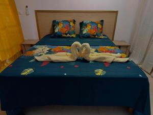 two swans made out of towels on a bed at Residence la Floride in Gros-Morne +6 photos
