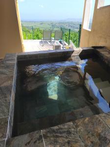 a pool of water in a house with a view at Residence la Floride in Gros-Morne