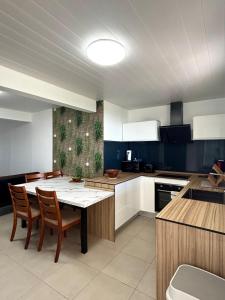a kitchen with a table and chairs in a room at Residence la Floride in Gros-Morne
