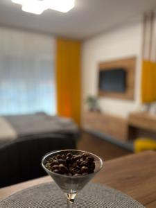a glass bowl of coffee beans sitting on a table at The Little Haven in Kragujevac