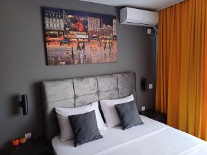 a bedroom with a large white bed with two pillows at The Little Haven in Kragujevac