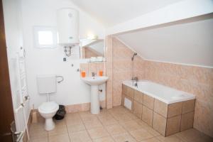 a bathroom with a sink and a tub and a toilet at Vile Mamaia Nord in Mamaia Sat/Năvodari +78 photos