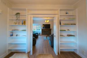 a room with white shelves in a living room at Home in Moe in Moe +17 photos