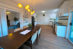 a kitchen and living room with a large table and chairs at Home in Moe in Moe