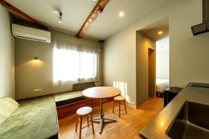 a small room with a table and two stools at B and D HAKUBA IWATAKE in Hakuba