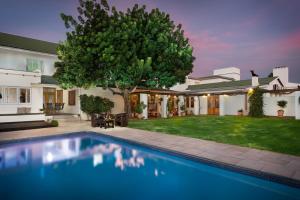 a swimming pool in the yard of a house at Citrusdal Country Lodge in Citrusdal