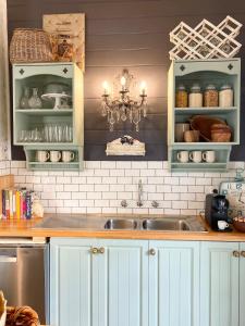 a kitchen with white cabinets and a sink at Korumburra Farmhouse in Korumburra