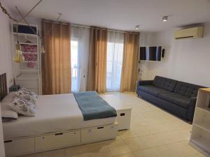 a living room with a bed and a couch at Mataró Center Studio in Mataró
