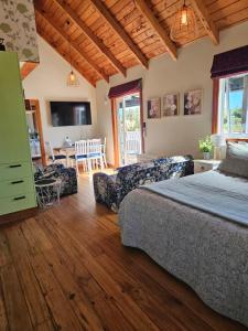 a bedroom with a bed and a living room at The Blackhouse Cottage in Hokitika