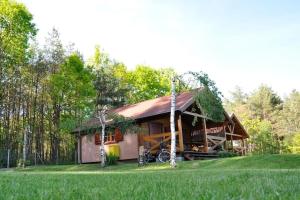 a small house with a bike parked in front of it at Summer cottages in Kashubia in Gostkowo +8 photos
