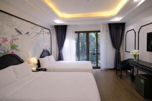 a hotel room with two beds and a piano at Stella De Boutique Hotel in Sapa +95 photos