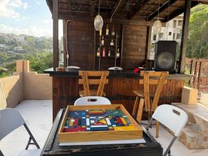 a table on a patio with chairs and a bar at 360 RokView Suites 3BR Spacious in Kingston