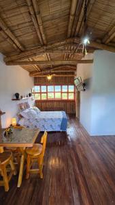 a bedroom with a bed and a table in a room at Cabaña Mirador Calima in Mediacanoa +11 photos