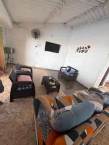 a living room with a couch and a flat screen tv at Villa Alejandro in Melgar