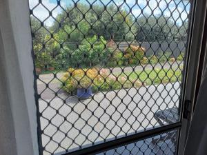 a view of a street through a chain link window at Marigold in Manurewa in Auckland