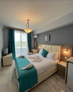 a bedroom with a large bed with blue accents at Bilali Apartments in Ulcinj +17 photos