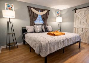 a bedroom with a bed with two lamps and a window at Pool house , near downtown SA in San Antonio