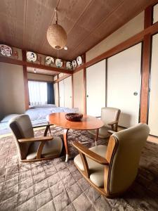 a room with a table and chairs and a bed at Mami and Ko house in Kawaguchi