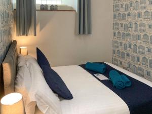 a bedroom with a bed with blue towels on it at The Boathouse in Appledore +16 photos
