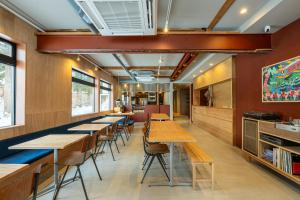a row of tables and chairs in a restaurant at B and D HAKUBA IWATAKE in Hakuba