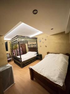 a bedroom with a bed and a clock on the ceiling at Old City Butik Hotel in Tashkent