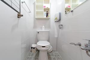 a white bathroom with a toilet and a sink at 다락방친구들 in T'ongyŏng
