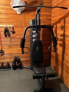 a treadmill in a room with a wooden wall at Colonial Guanacaste Villas in Guanacaste