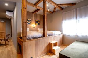 a bedroom with two beds and a mirror in it at B and D HAKUBA IWATAKE in Hakuba +57 photos