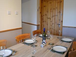 a table with glasses and a bottle of wine on it at West Tannacrieff in Stewarton