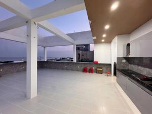 a large white kitchen with a view of the ocean at Phao Hotel in Vung Tau