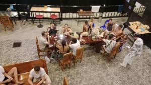 a group of people sitting around a table at Dee-maak Hostel in Thong Sala