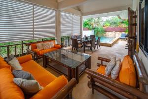 a living room with orange furniture and a table at Malee Beach C6 in Phra Ae beach