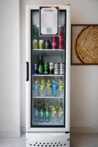 an open refrigerator filled with bottles and drinks at Pousada Doce Mar in Maragogi
