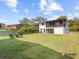 a house with a large lawn in front of it at Iluka Magic in Iluka