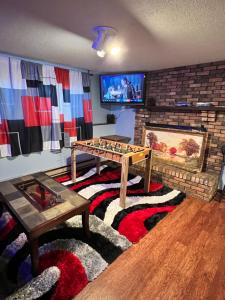 a living room with a table and a fireplace at MidwestBNB Room1, quite cabin in the wood vibes in Minneapolis
