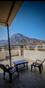 a patio with a table and chairs on a roof at Nandi Holiday Homestay in Nandi
