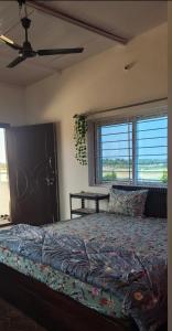 a bedroom with a bed and a ceiling fan at Nandi Holiday Homestay in Nandi