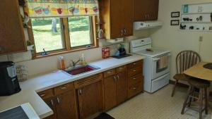 a kitchen with a sink and a stove at Yellow Barn House in Danbury