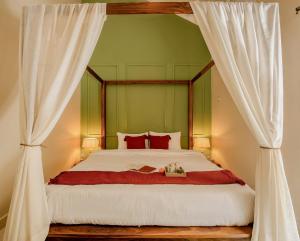 a bedroom with a bed with a canopy at Casa Superfly 2BHK with Rooftop Jacuzzi & Terrace Deck Excellent Location Boilermaker Thalassa in Oxel